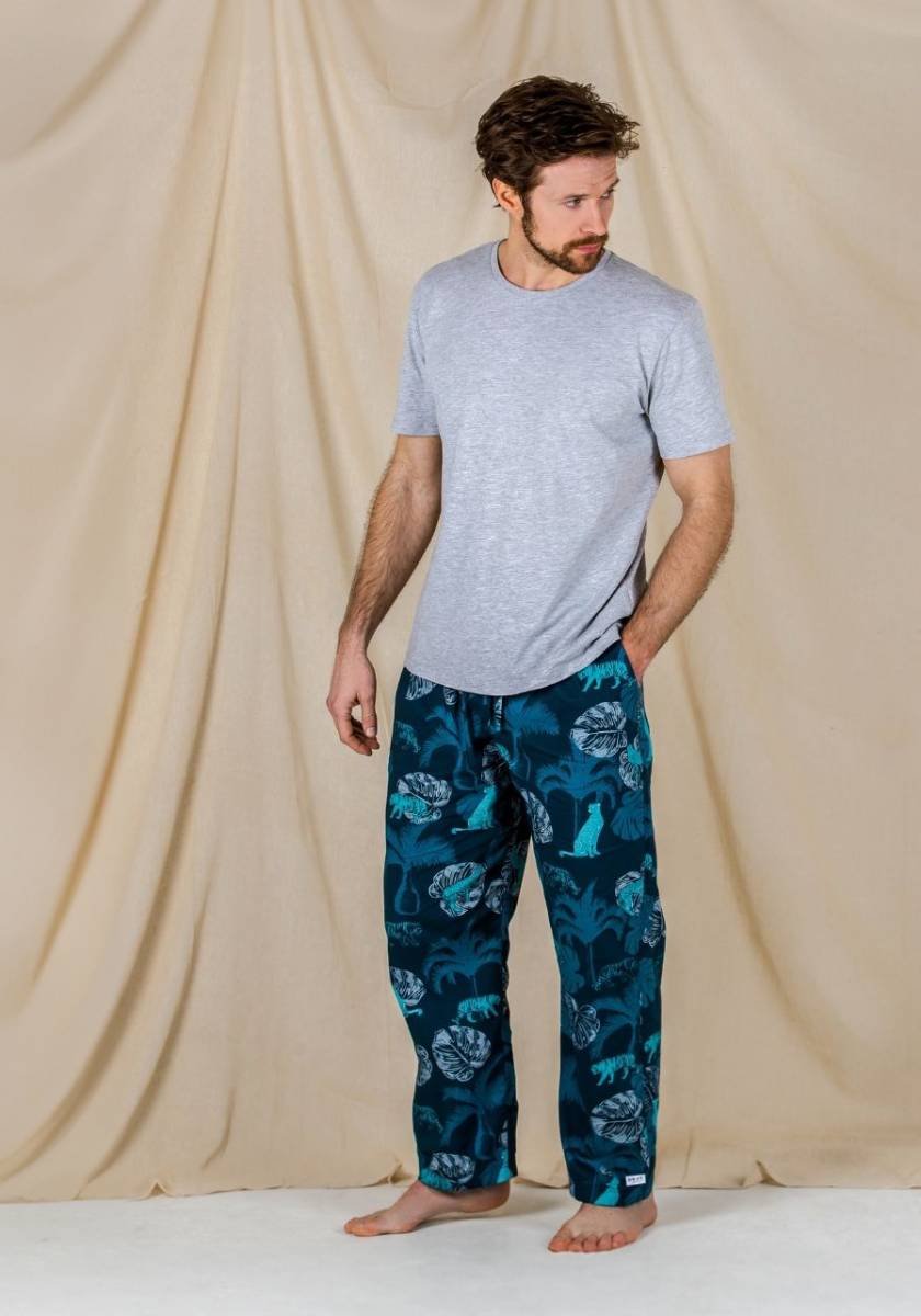 Drift sleepwear model wearing the tropics cotton pyjama bottoms set paired with a grey organic cotton t-shirt