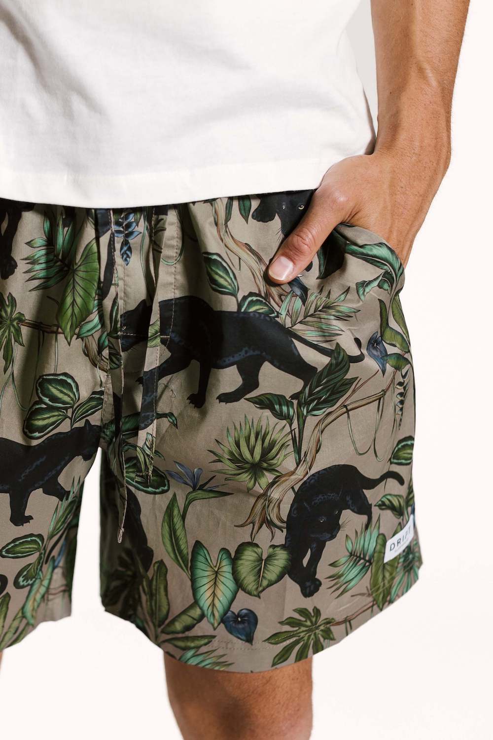 Model wearing mens organic cotton pyjama shorts with a white cotton pj top close up