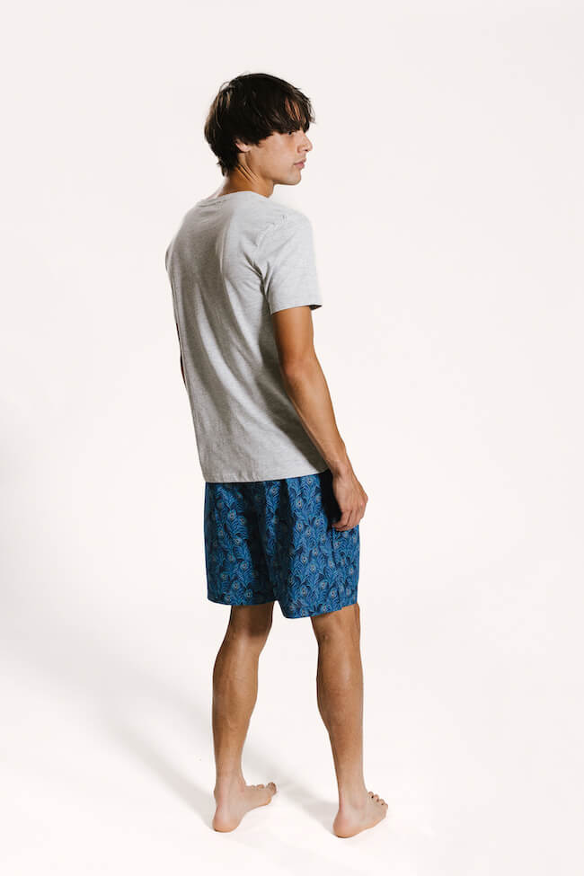 Model wearing organic cotton mens peacock printed 'hera' mens sleepwear shorts set