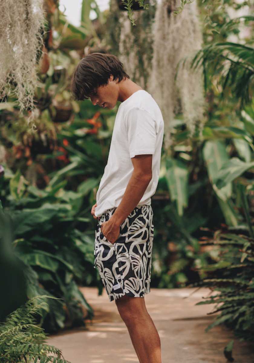 Model wearing panama printed mens pyjama shorts with a white organic cotton pyjama top