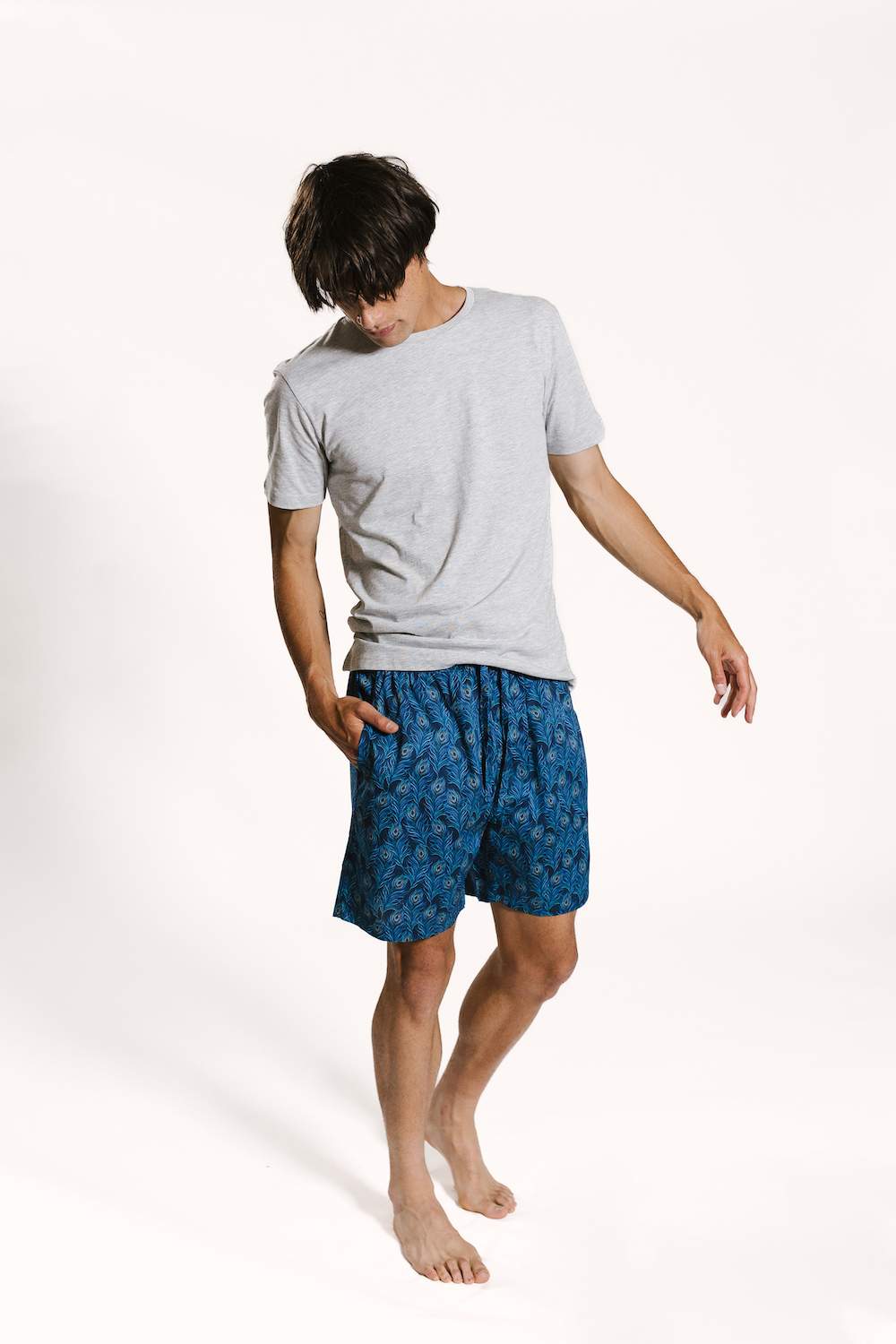 Model wearing organic cotton mens peacock printed 'hera' mens pyjama shorts set