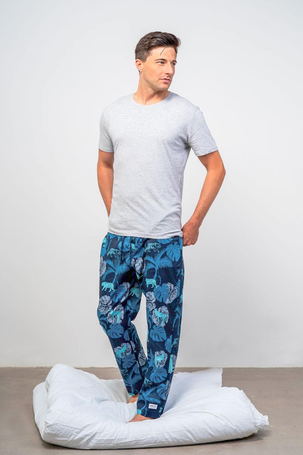 Model wearing luxury sleepwear bottoms and grey organic t-shirt