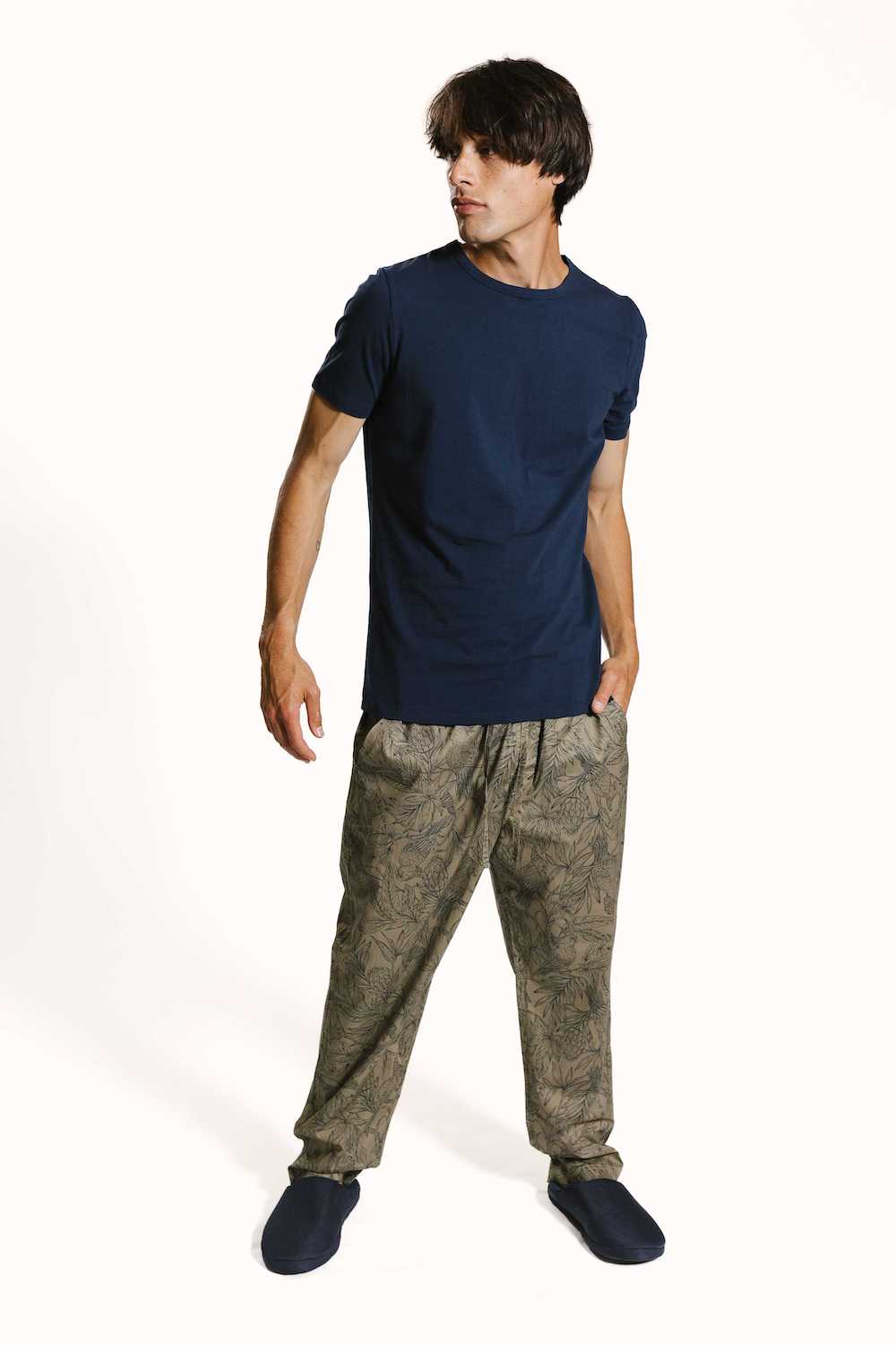 moluccan cockatoo pyjama bottoms on model with navy organic cotton t-shirt